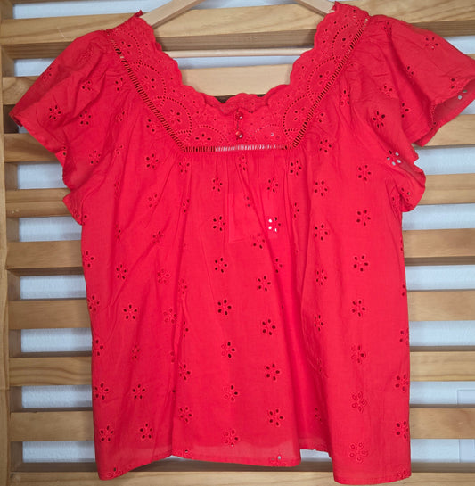 Women's red eyelet blouse with floral embroidery and short flutter sleeves.