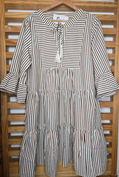 Lightweight cotton dress featuring classic color chocolate stripes, flowy bell sleeves, and a tassel tie neckline for a relaxed boho-inspired look. The loose silhouette offers comfort and movement, while the side pockets add everyday practicality. A charming and feminine piece that’s perfect for casual days or relaxed outings