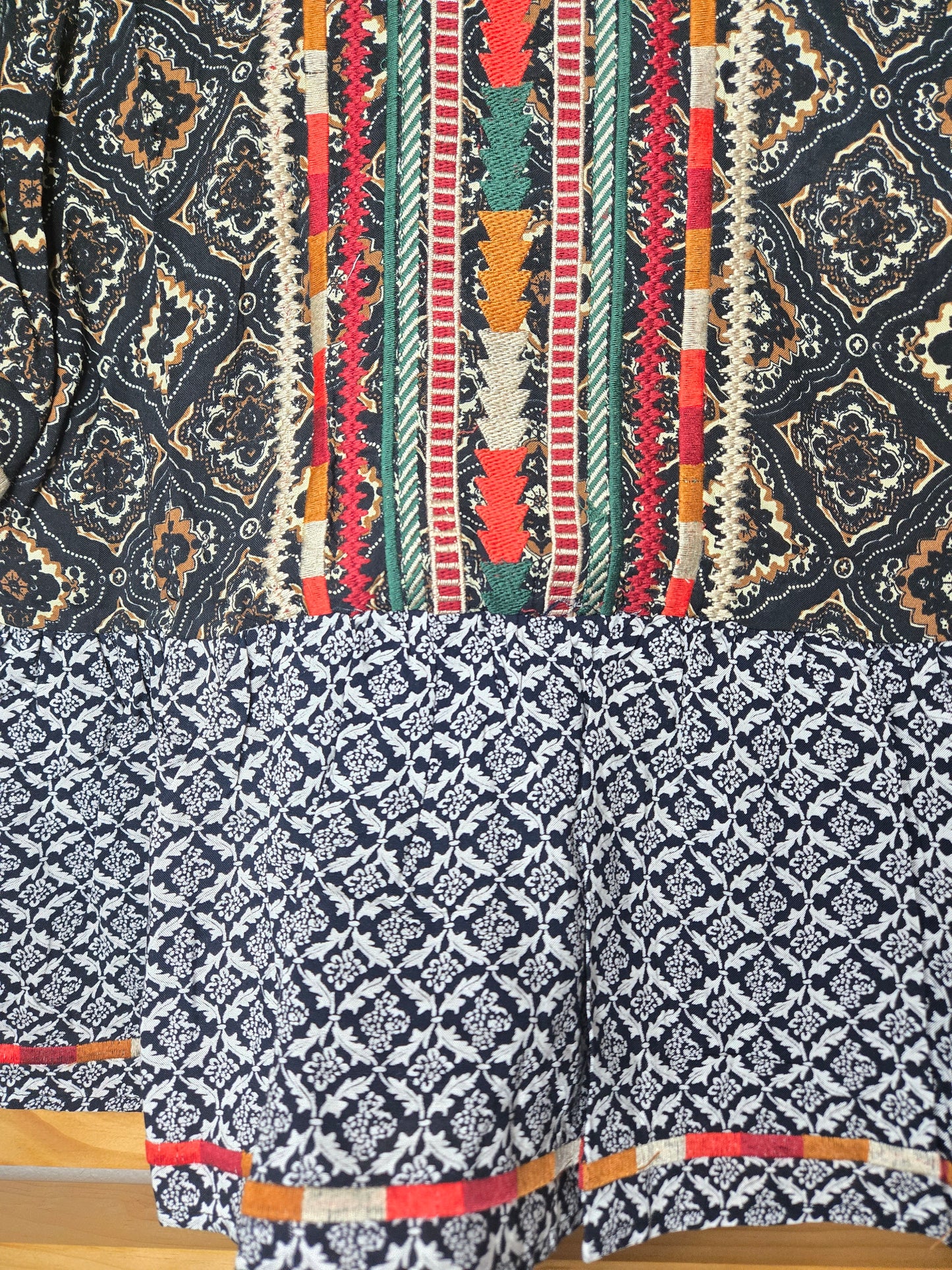 This piece is perfect for lovers of boho embroidered tops, mixed print blouses, and romantic bohemian clothing. A versatile short sleeve boho top designed for women who appreciate feminine, effortless style.