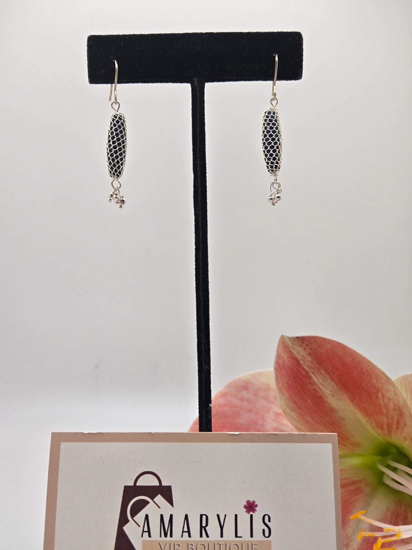 Red stone dangle earrings wrapped in metallic wire.