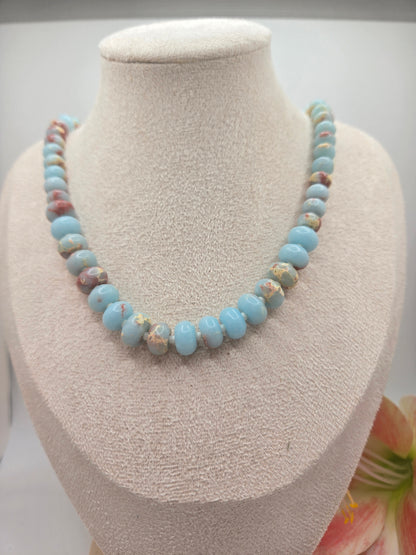 Semi-precious gemstone necklace featuring smooth sky-blue rondelle beads with natural brown matrix accents and delicate spacer beads.