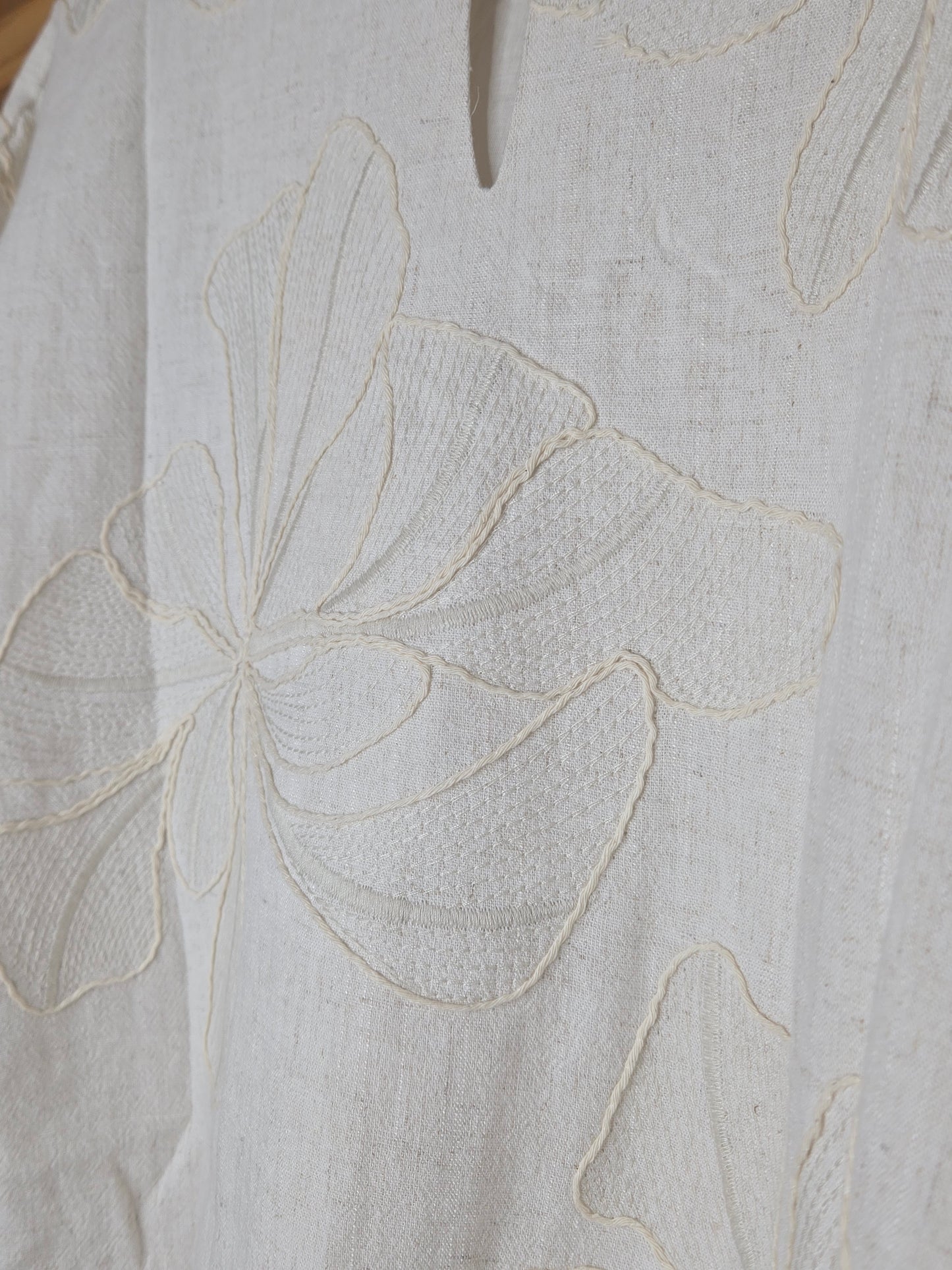 Beige linen-blend top with floral embroidery, featuring short dolman sleeves with elastic cuffs and a soft inner lining