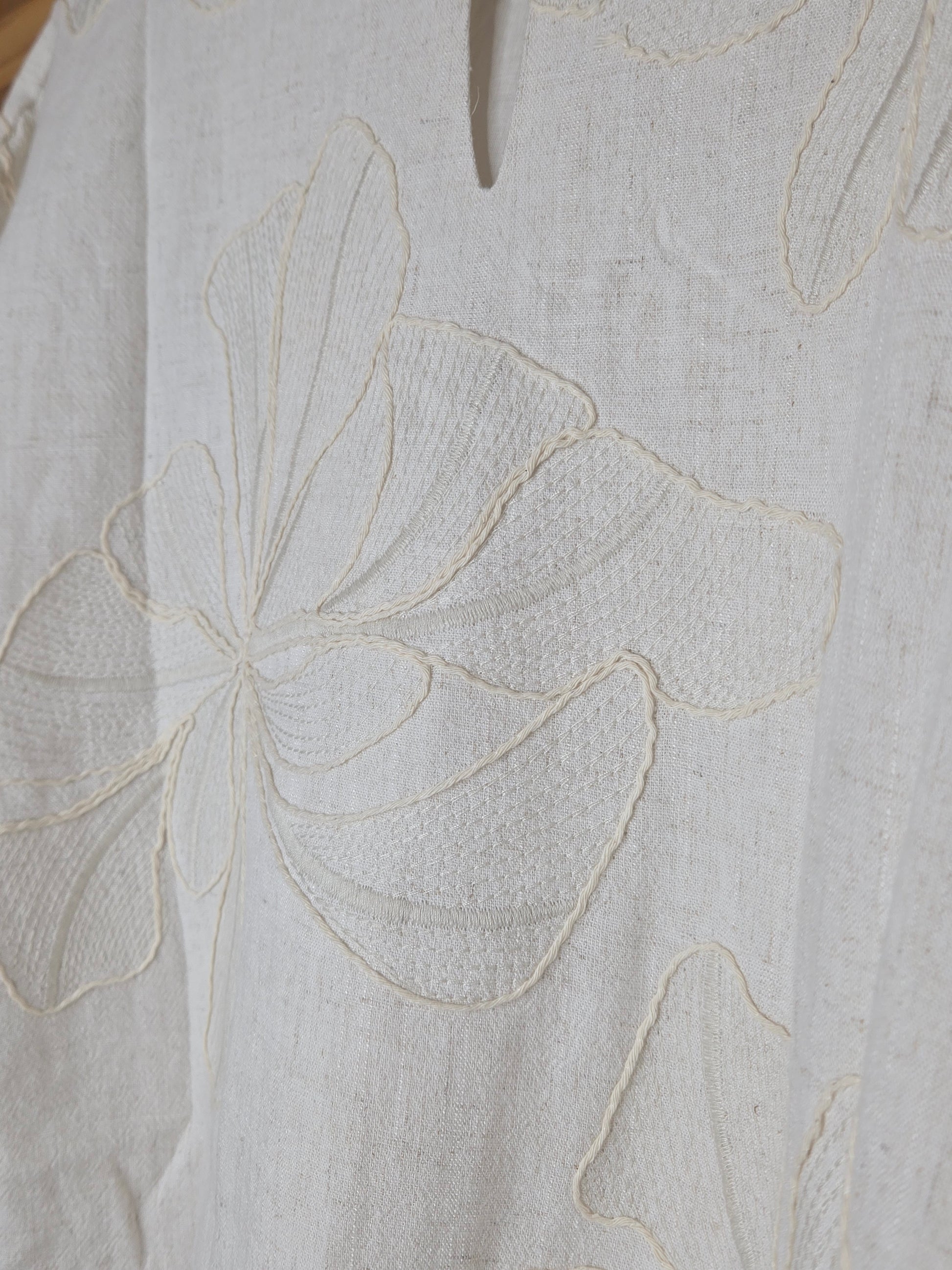 Beige linen-blend top with floral embroidery, featuring short dolman sleeves with elastic cuffs and a soft inner lining
