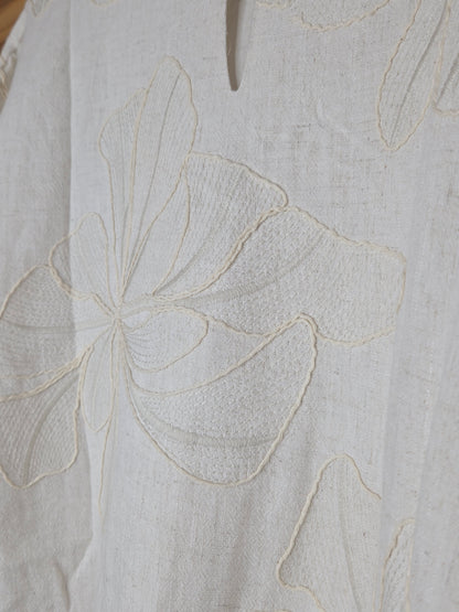 Beige linen-blend top with floral embroidery, featuring short dolman sleeves with elastic cuffs and a soft inner lining