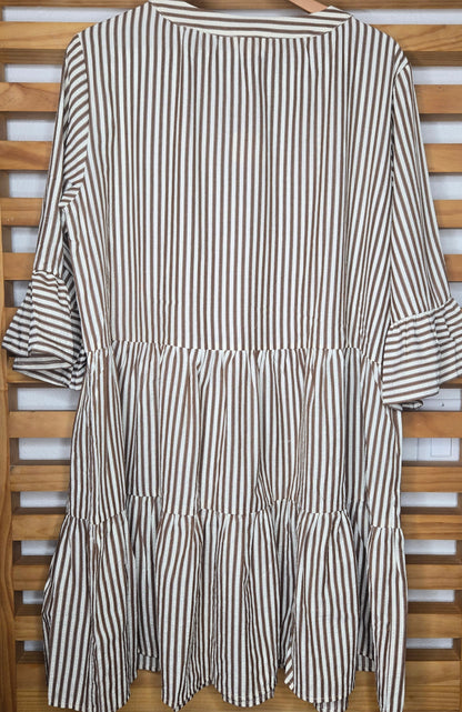 Lightweight cotton dress featuring classic color chocolate stripes, flowy bell sleeves, and a tassel tie neckline for a relaxed boho-inspired look. The loose silhouette offers comfort and movement, while the side pockets add everyday practicality. A charming and feminine piece that’s perfect for casual days or relaxed outings