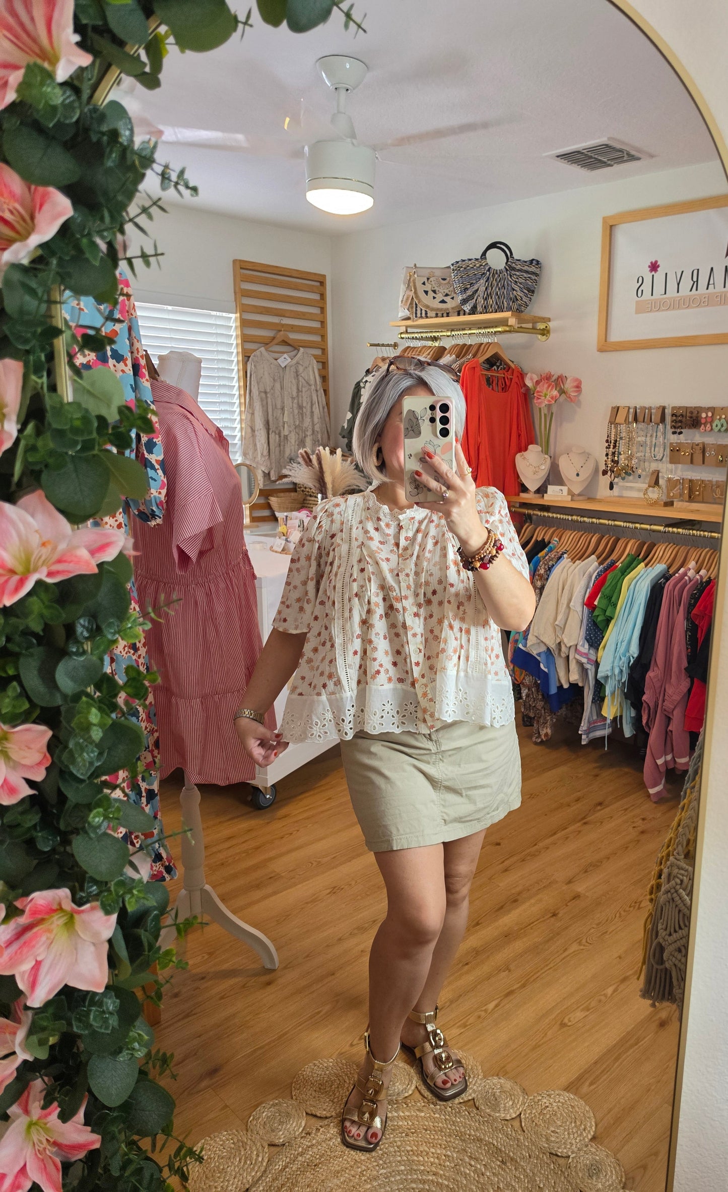 Floral print blouse with lace trim, flutter sleeves, and button-front closure