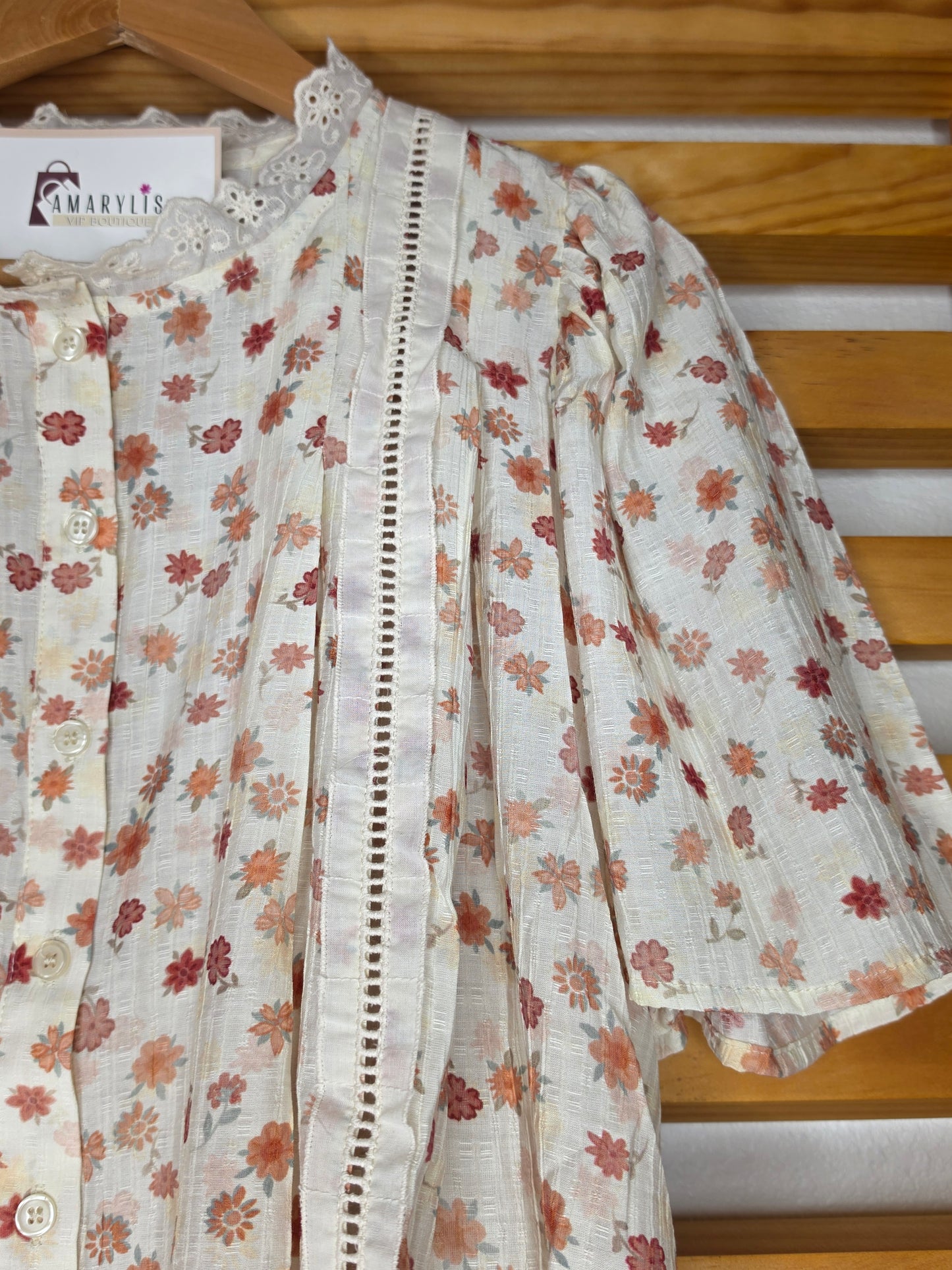 Floral print blouse with lace trim, flutter sleeves, and button-front closure