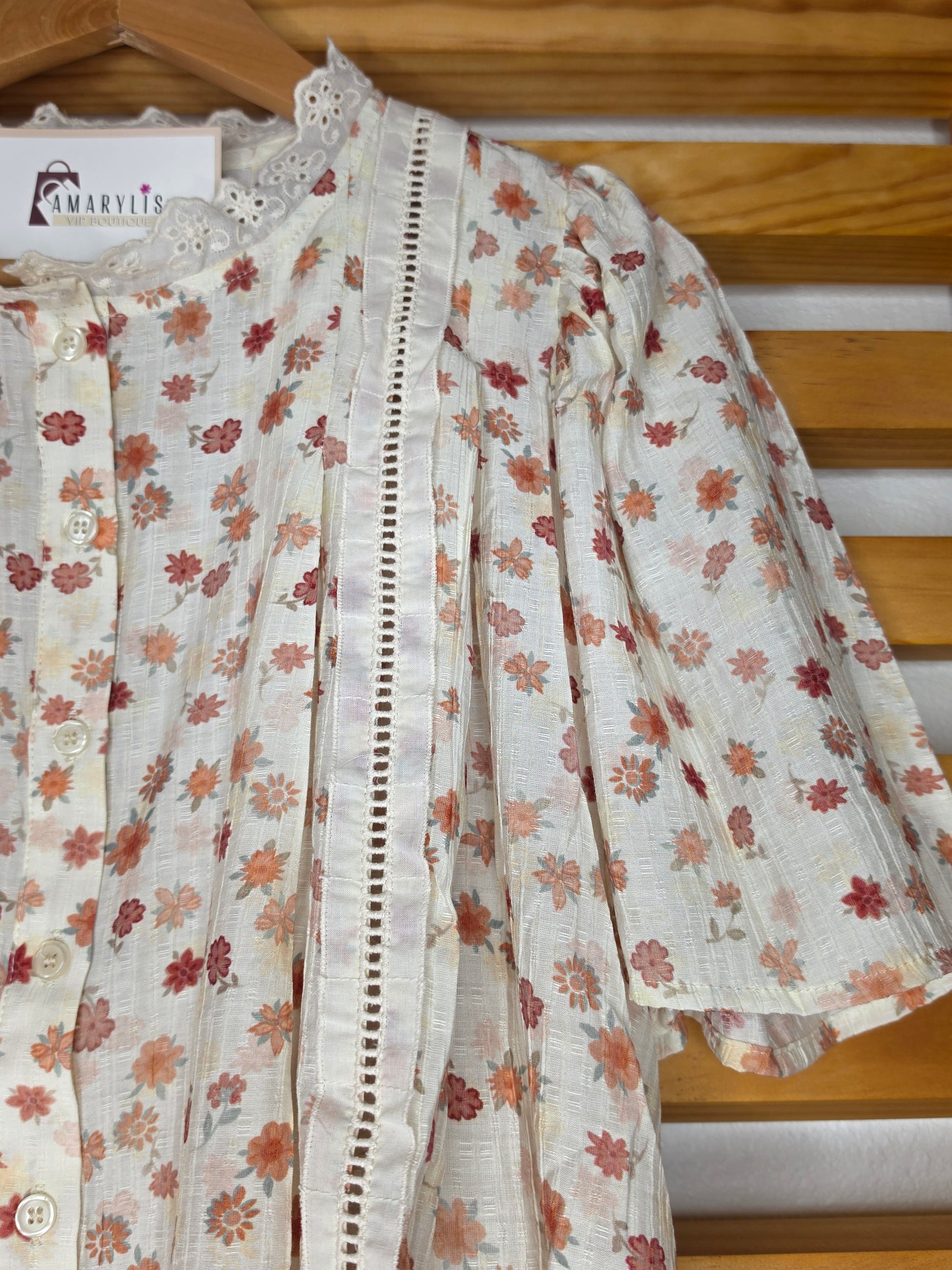 Floral print blouse with lace trim, flutter sleeves, and button-front closure