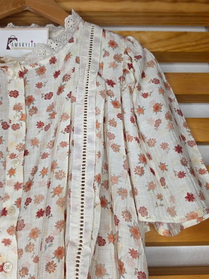 Floral print blouse with lace trim, flutter sleeves, and button-front closure