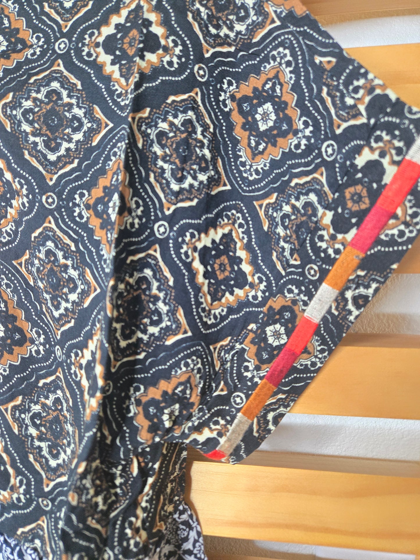 This piece is perfect for lovers of boho embroidered tops, mixed print blouses, and romantic bohemian clothing. A versatile short sleeve boho top designed for women who appreciate feminine, effortless style.