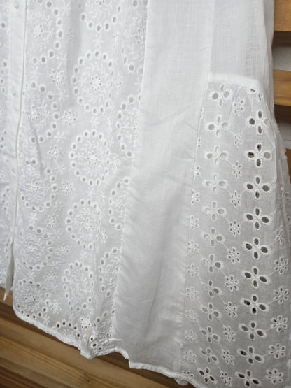 Lightweight shirt dress with eyelet embroidery, button-front closure, short flutter sleeves, and a soft, feminine silhouette.