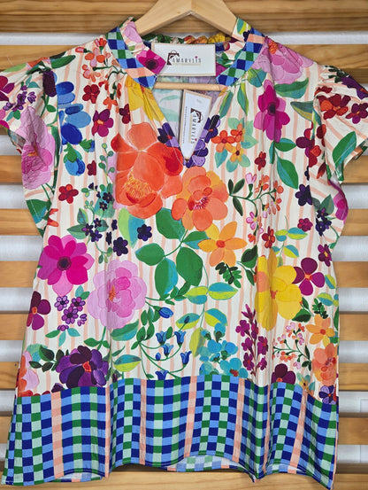 Lightweight blouse featuring soft flutter sleeves and a delicate floral border print. Designed with a feminine ruffled V-neckline, perfect for an effortless boho-inspired look.