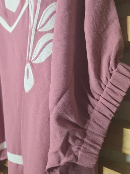 Women's dusty rose embroidered blouse featuring floral embroidery, contrast striped rib trim, short sleeves, and a relaxed fit.