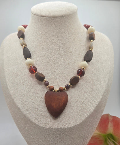 Wooden bead necklace featuring a heart-shaped pendant with a feminine and bohemian-inspired design.