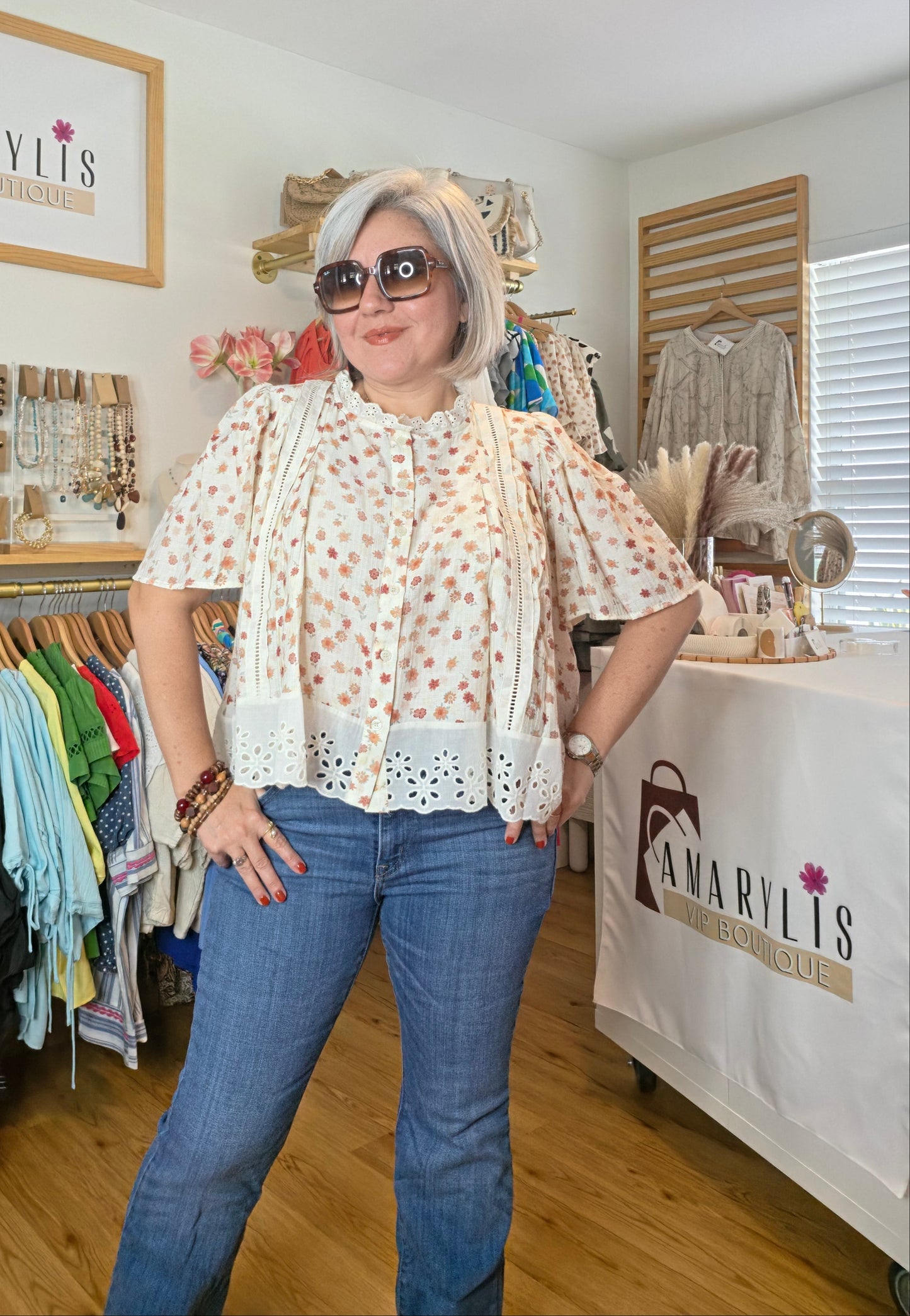 Floral print blouse with lace trim, flutter sleeves, and button-front closure