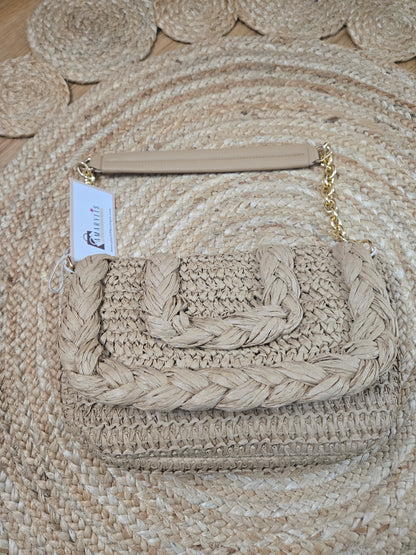 Woven raffia flap shoulder bag with textured natural fibers and structured silhouette