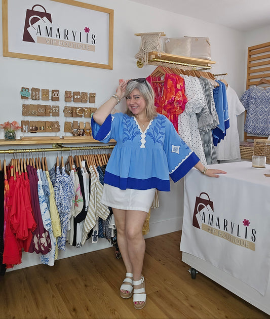 Blue blouse with embroidery and plunging V-neck, featuring contrasting trim