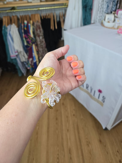 Handcrafted adjustable gold-tone bracelet featuring a clear flower-shaped charm, lightweight waterproof design, and artisan-crafted details for everyday wear.