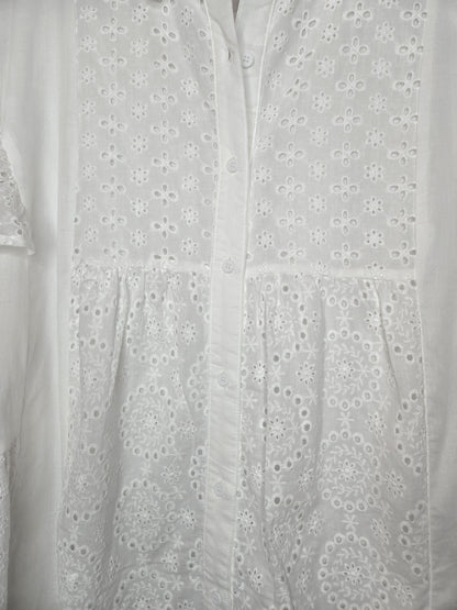 Lightweight shirt dress with eyelet embroidery, button-front closure, short flutter sleeves, and a soft, feminine silhouette.