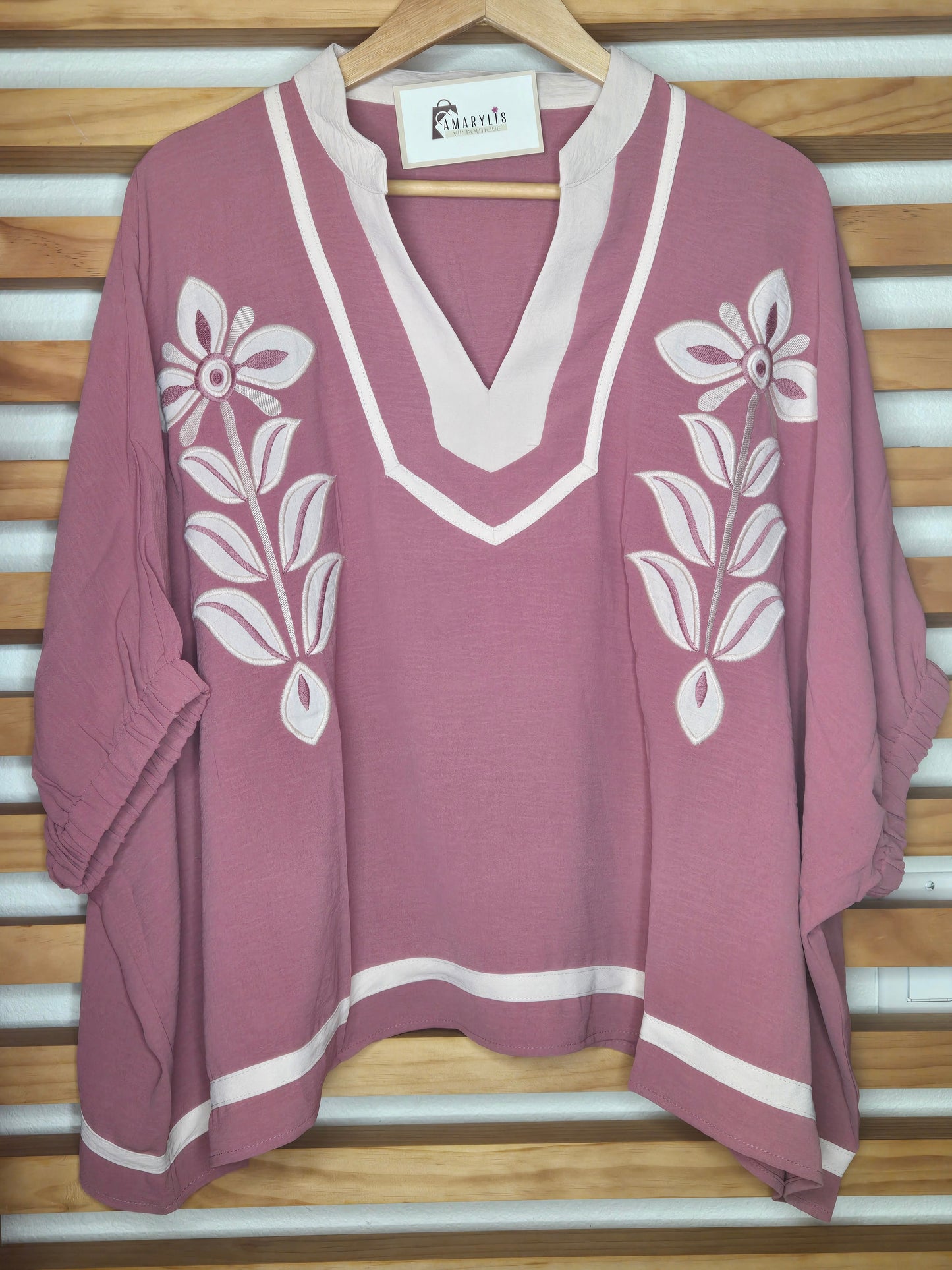 Women's dusty rose embroidered blouse featuring floral embroidery, contrast striped rib trim, short sleeves, and a relaxed fit.