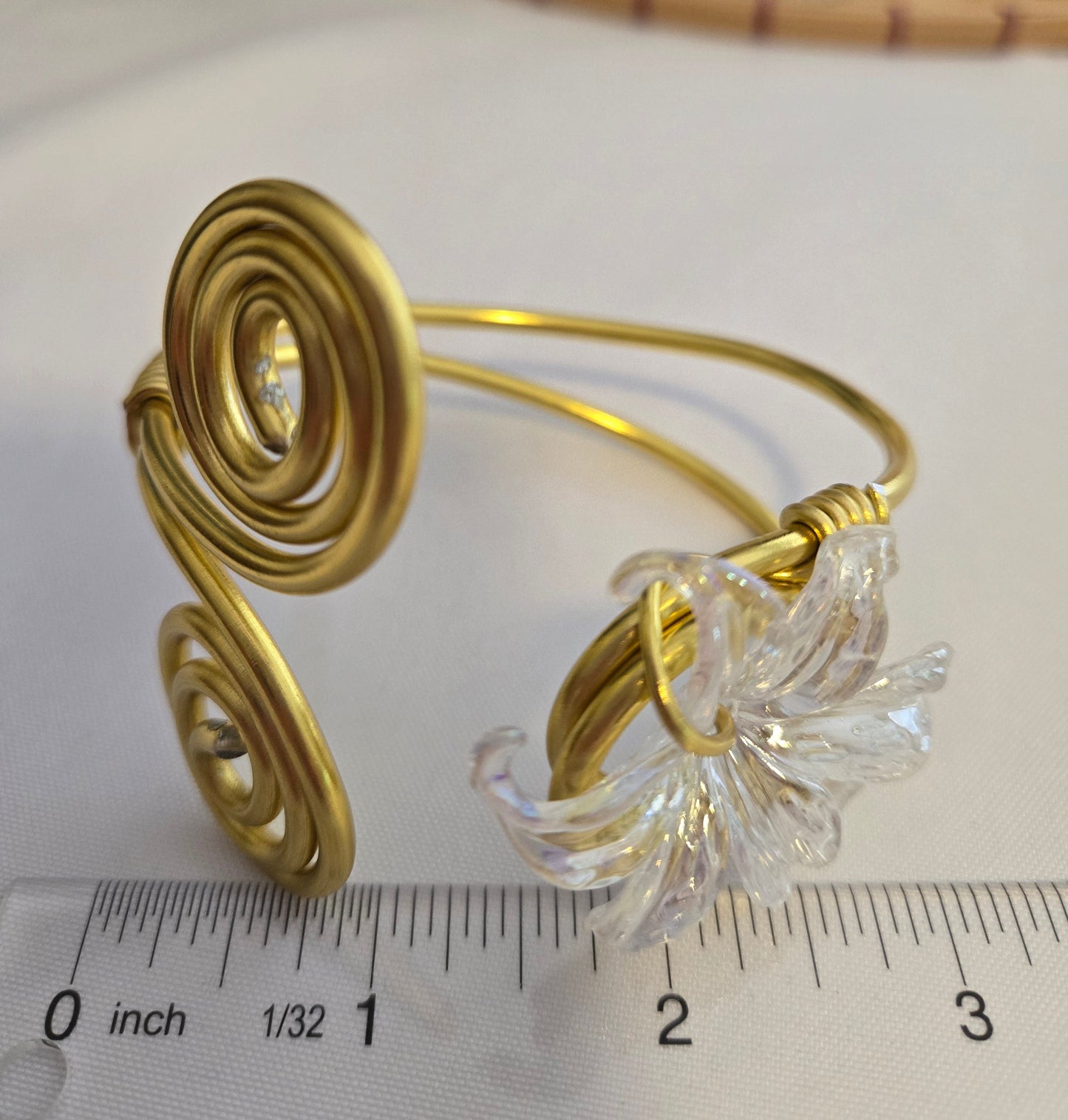 Handcrafted adjustable gold-tone bracelet featuring a clear flower-shaped charm, lightweight waterproof design, and artisan-crafted details for everyday wear.