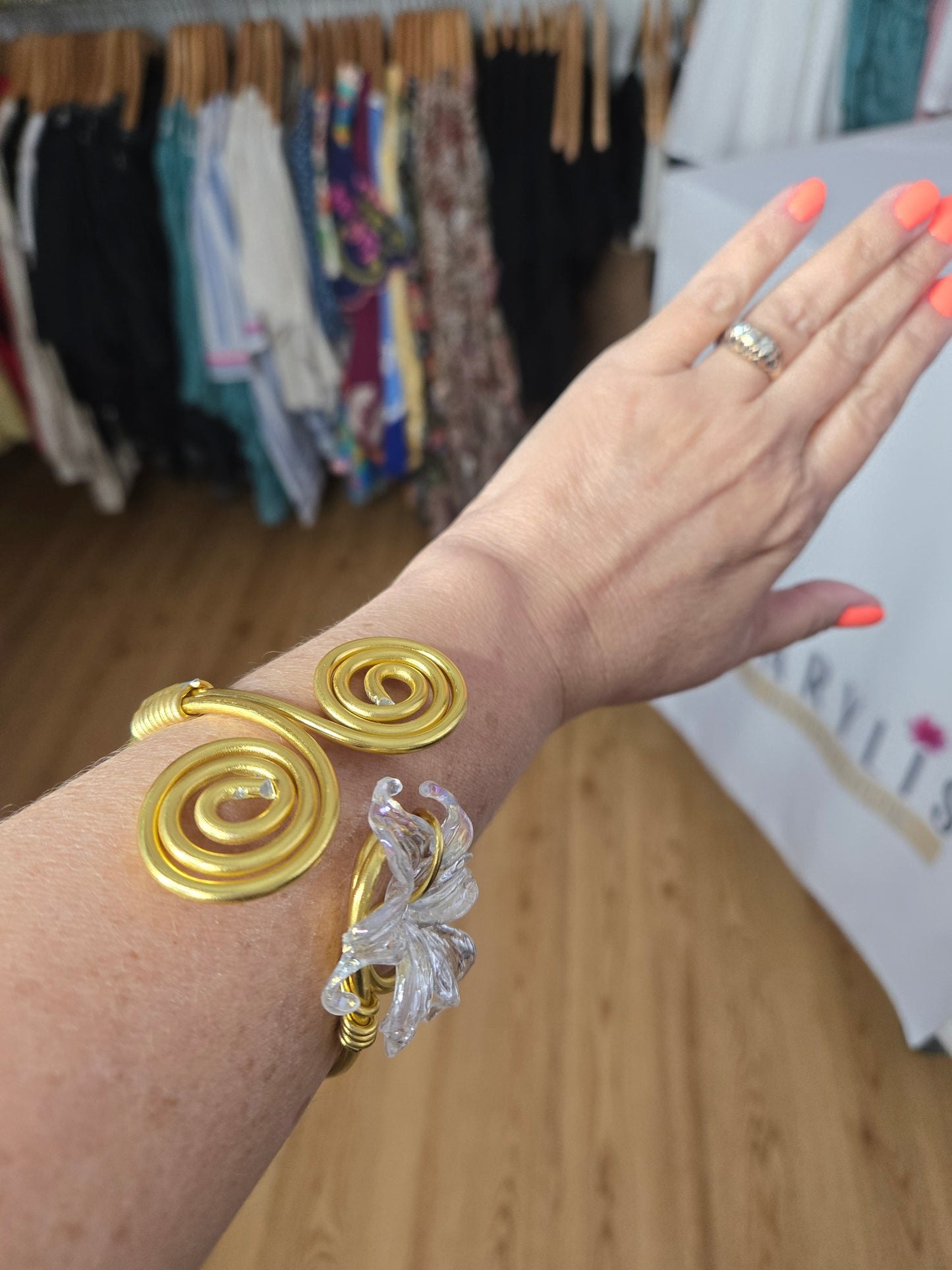 Handcrafted adjustable gold-tone bracelet featuring a clear flower-shaped charm, lightweight waterproof design, and artisan-crafted details for everyday wear.
