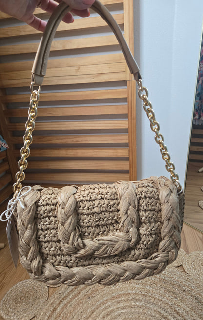 Woven raffia flap shoulder bag with textured natural fibers and structured silhouette