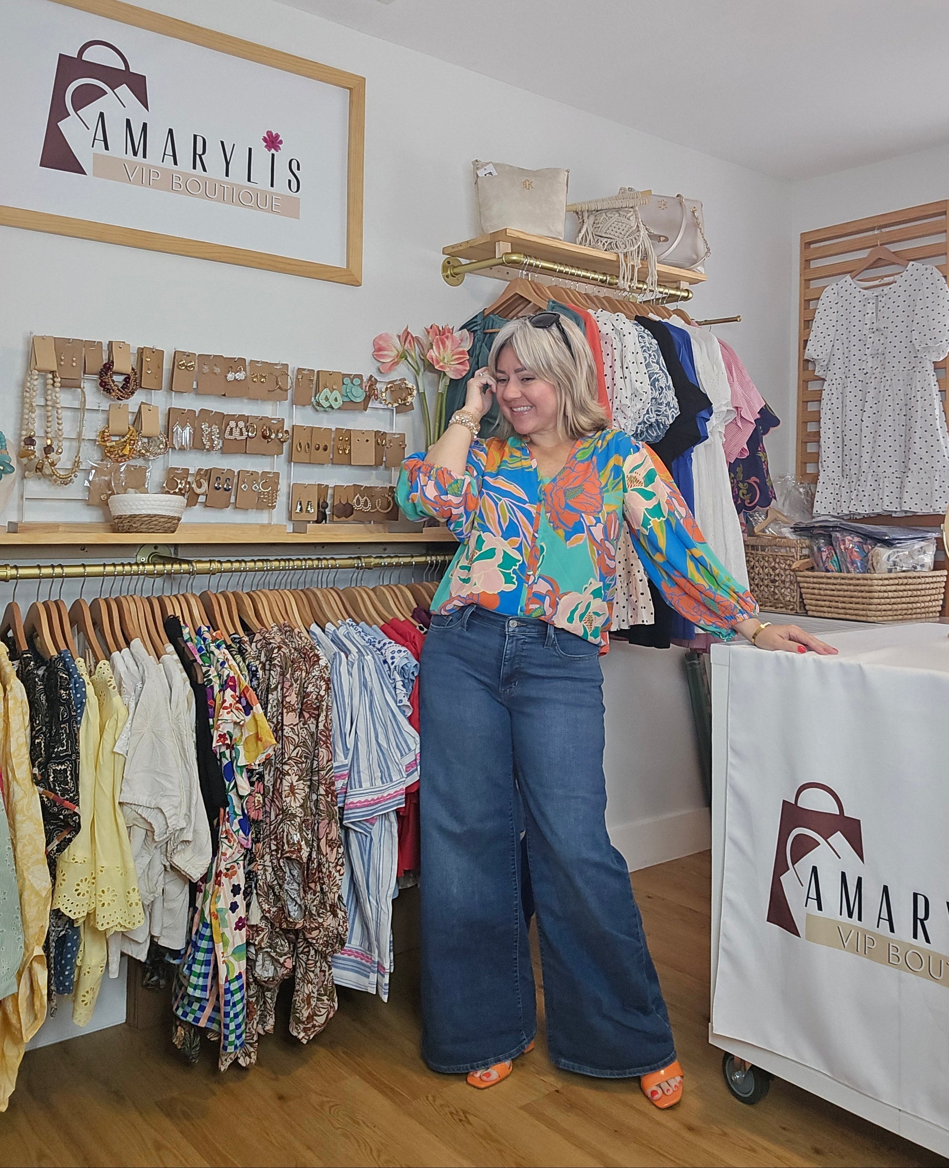 Floral printed blouse featuring 3/4 sleeves and a soft ruffled neckline detail.
