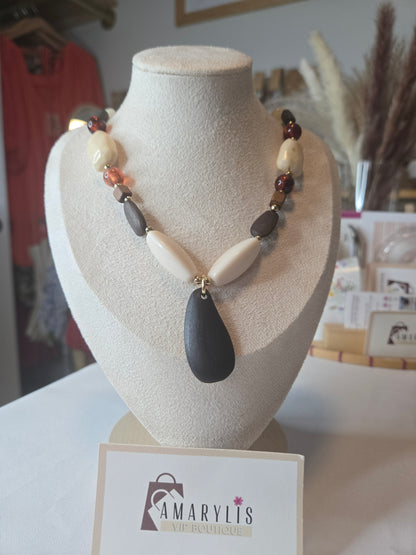 A timeless wood bead necklace with a graceful teardrop pendant, designed to bring natural beauty and effortless elegance to your wardrobe.