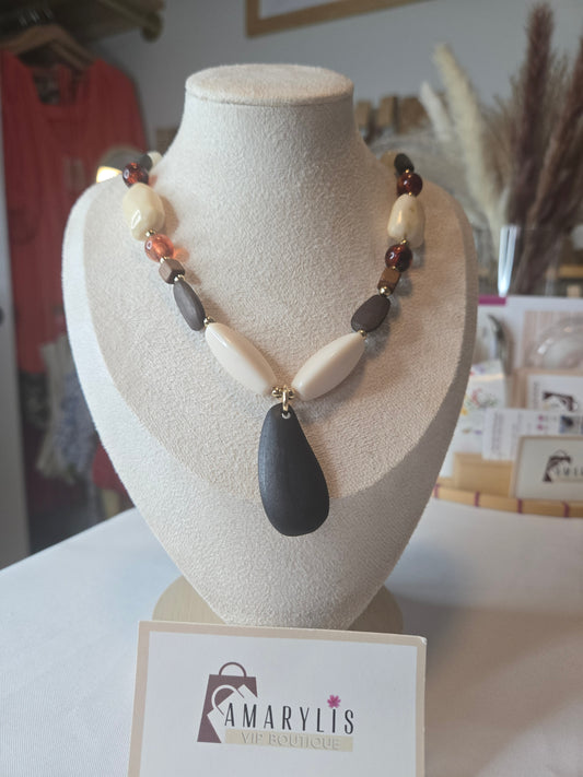 A timeless wood bead necklace with a graceful teardrop pendant, designed to bring natural beauty and effortless elegance to your wardrobe.