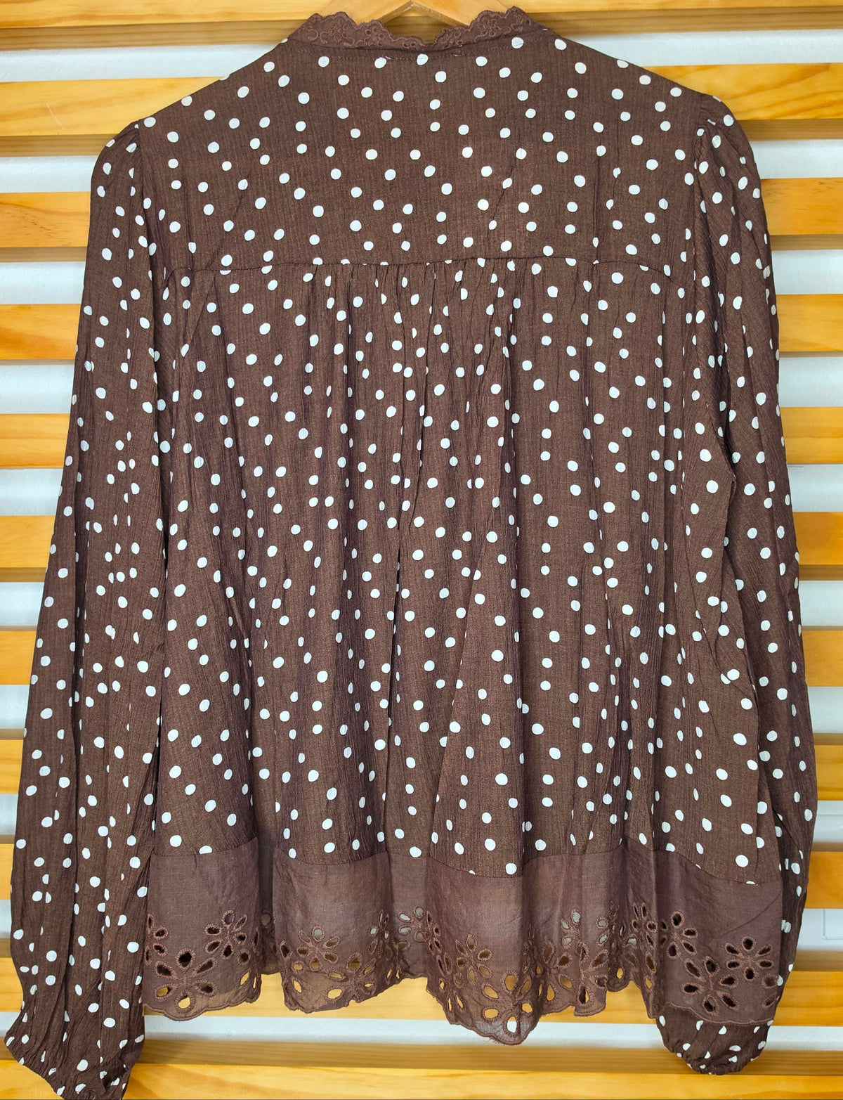 Women's polka dot blouse with scalloped lace neckline, vertical lace inserts, flowing sleeves, button-front closure, and wide eyelet lace hem
